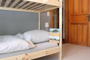 a bunk bed in a bedroom with a wooden bed frame at Ferienwohnung Hof Alms in Uelzen +18 photos