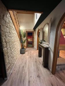 a hallway of a house with a stone wall at La Belle au Bois Joli in Raon-lʼÉtape +24 photos