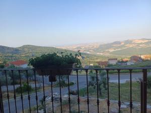 a balcony with a view of a river and mountains at A casa di Meggie in Dogliola