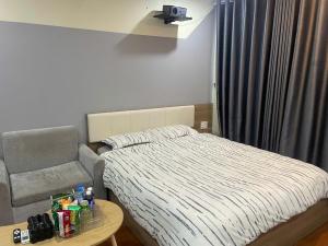 a small bedroom with a bed and a chair at Flick Zone Trung Lực in Lực Hánh