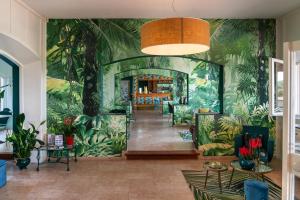 a lobby with a mural of plants on the wall at West Garda Hotel in Padenghe sul Garda +65 photos
