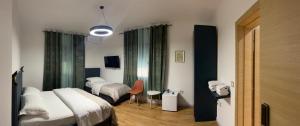 a hotel room with two beds and a table at ERA Vila 36 Durres in Durrës