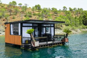 a house on the water with palm trees on it at Dream house in Rragam