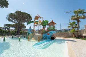 a water park with a slide in the water at Park Gallanti in Lido di Pomposa