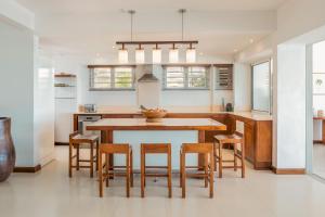 a kitchen with a wooden table and chairs at Villa Karma by muse villas in Grand-Baie
