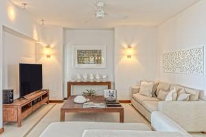 a living room with a couch and a table at Villa Karma by muse villas in Grand-Baie