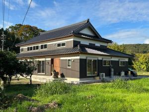 a home with a black and white house at Kibe House in Kunisaki
