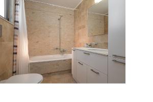 a bathroom with a tub and a toilet and a shower at Beach Bar VIlla in Lefkada +5 photos