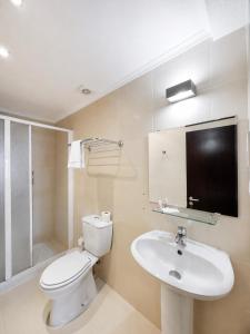 a bathroom with a white toilet and a sink at Residência São Francisco by Umbral in Fátima +6 photos