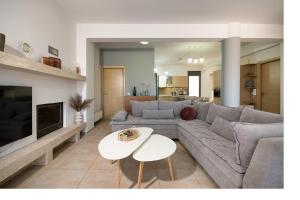 a living room with a couch and a table at Beach Bar VIlla in Lefkada