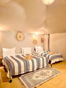 a room with two beds in a room at Authentic Luxury Camp in Merzouga +74 photos