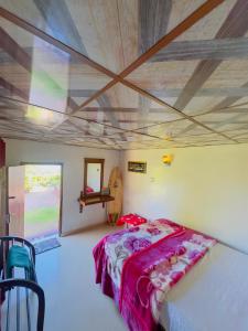 a bedroom with a bed and a wooden ceiling at Sana's homestay haputhale in Haputale