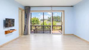 an empty room with an open door to a balcony at Samcheok Good Friend Pension in Samcheok