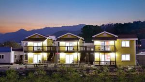 a row of houses with their lights on at Samcheok Good Friend Pension in Samcheok