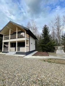 a large white house with a large driveway at InMonteHouse in Migovo
