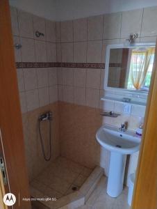 a bathroom with a shower and a sink at Catalina studios 2 in Olympic Beach