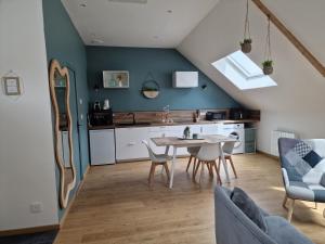 a kitchen and dining room with a table and chairs at Cap Ouest in Fécamp