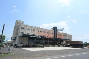 a large building on the side of a street at Shubhratna Hotel & Resort in Ujjain