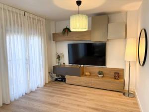 a living room with a flat screen tv on a wall at Placituela 7 in San Esteban de Gormaz