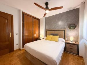 a bedroom with a bed with a ceiling fan at Placituela 7 in San Esteban de Gormaz