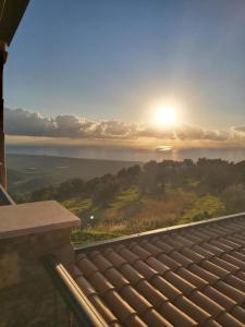 a view of the sunset from the roof of a house at Casolare La Mirabella 