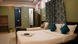 a hotel room with two beds in a room at FabHotels Divo in Chennai