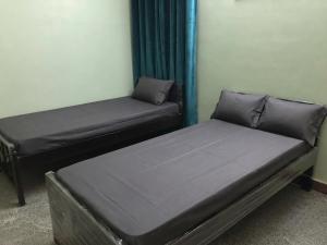 two twin beds in a room with a window at FabHotels Divo in Chennai