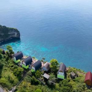 an aerial view of a group of houses by the water at Suwehan Blue Ocean Cliff in Semarapura