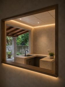 a mirror on the wall of a kitchen with a sink at Atithya Retreat in Hikkaduwa