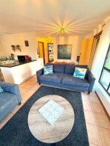 a living room with a couch and a table at NR 4 Cove Apartment Carrickalinga in Carrickalinga