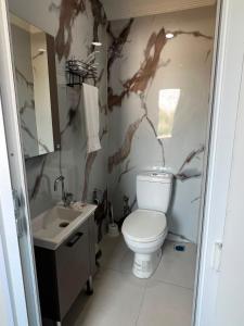 a bathroom with a toilet and a sink at Stone Hotel Belek in Belek