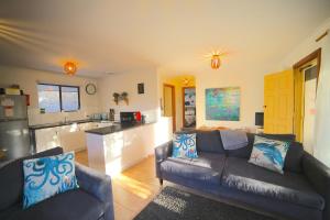 a living room with a couch and a kitchen at NR 4 Cove Apartment Carrickalinga in Carrickalinga +5 photos