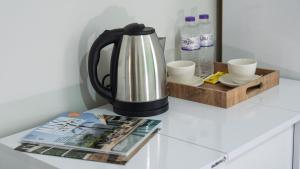 a coffee pot and a magazine on a counter at Stone Hotel Belek in Belek