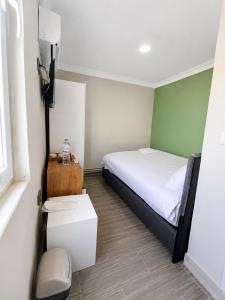 a small bedroom with a bed and a window at Stone Hotel Belek in Belek