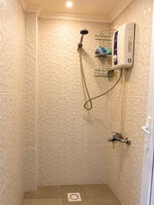 a bathroom with a shower with a blow dryer on the wall at Stone Hotel Belek in Belek