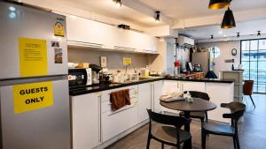 a kitchen with a table and chairs in a room at The Blocks Hostel Sukhumvit 10 in Bangkok +24 photos