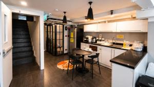a kitchen with a table and chairs in a room at The Blocks Hostel Sukhumvit 10 in Bangkok