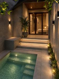 a house with a swimming pool and a bedroom at Atithya Retreat in Hikkaduwa