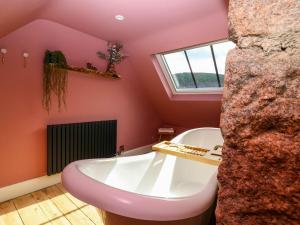 a bathroom with a bath tub and a window at Evansford in Ballater +37 photos