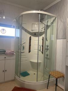 a shower with a glass enclosure in a bathroom at Une nuit près de l'eau in Hallines