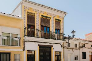 an apartment building with a balcony and a door at La Casona Beach House in Valencia