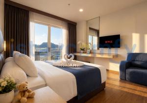 a bedroom with a large bed with a teddy bear on it at Studio Aston Residence 0306 City View in Nagoya