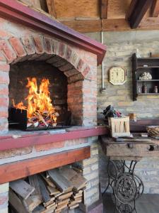 a brick oven with a fire in it at Vila Josipa in Vukovar