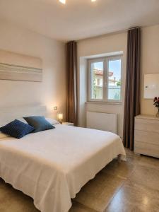 a bedroom with a large white bed and a window at B&B da Cencia in Monte San Biagio