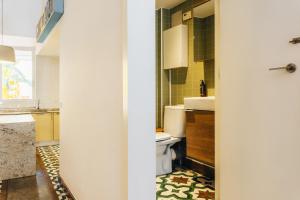a bathroom with a toilet and a sink at La Casona Beach House in Valencia +49 photos