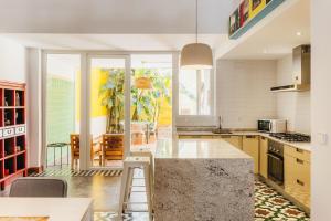 a kitchen with a large island in the middle at La Casona Beach House in Valencia