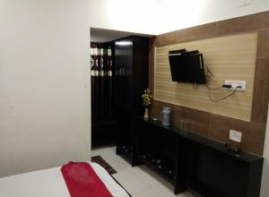 a bedroom with a bed and a tv on a wall at hotel shivay in Basti