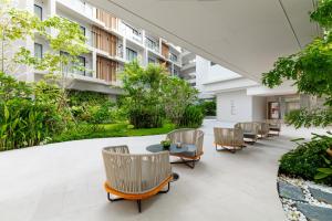 an internal courtyard of a building with chairs and tables at Radisson Resort Layan Phuket in Layan Beach +291 photos
