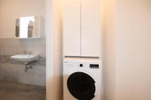 eine Waschmaschine in einem Badezimmer mit Waschbecken in der Unterkunft Residenza Capriolo 28 - F&L Apartment in Brescia + 90 Fotos