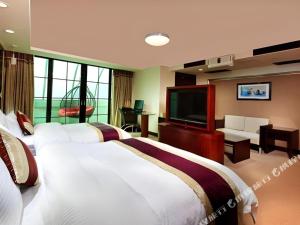 a hotel room with three beds and a flat screen tv at New World Hotel in Guangzhou +286 photos